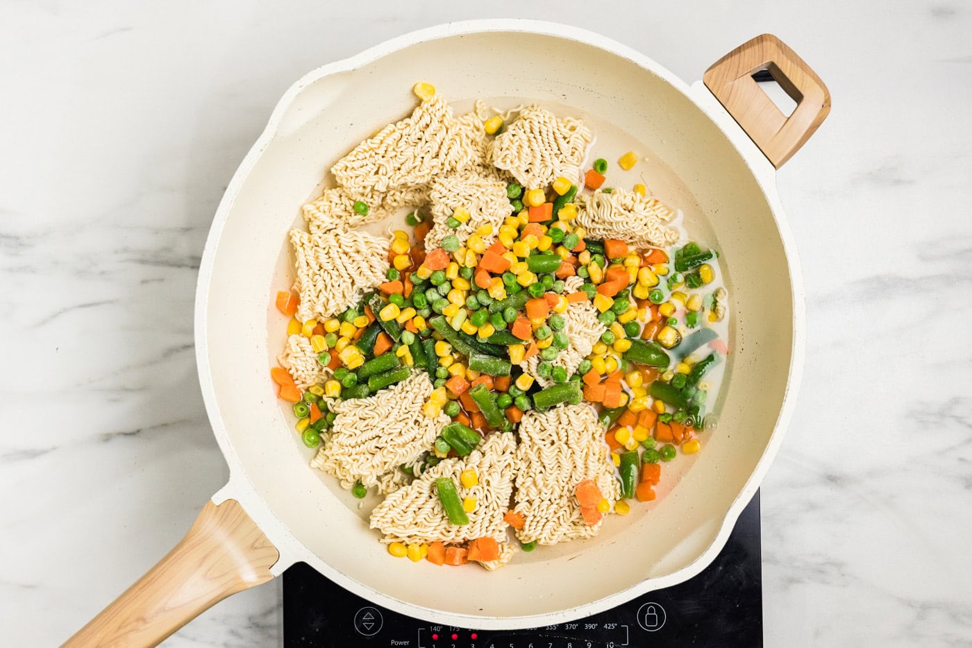 dry ramen noodles and vegetables in skillet