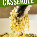CLOSE UP OF TONGS LIFTING RAMEN NOODLE CASSEROLE WITH TEXT OVERLAY