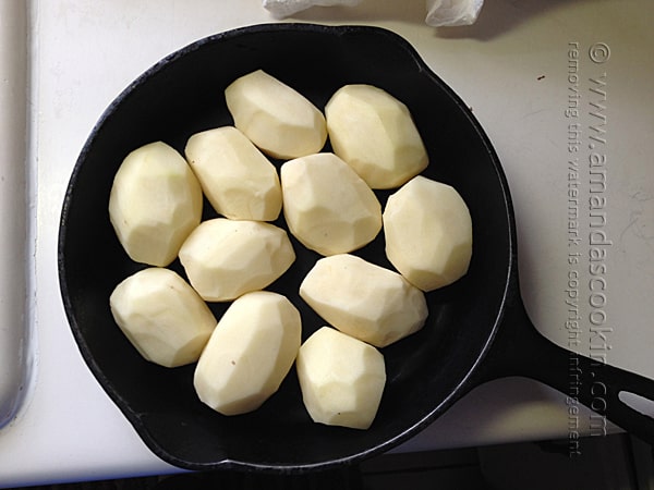 Peel the potatoes and fit them snugly together in the skillet