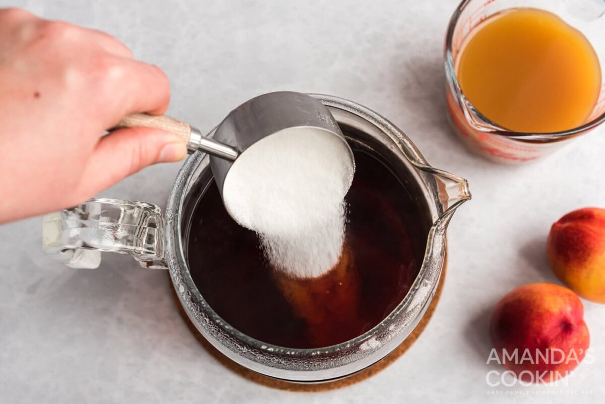 adding sugar to tea