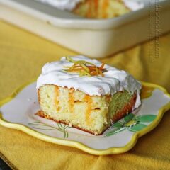A piece of citrus lover's poke cake on a square plate.