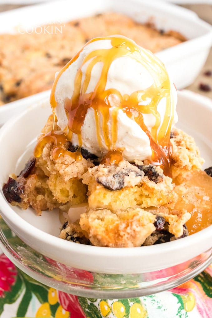 bowl of cranberry apple cobbler with ice cream