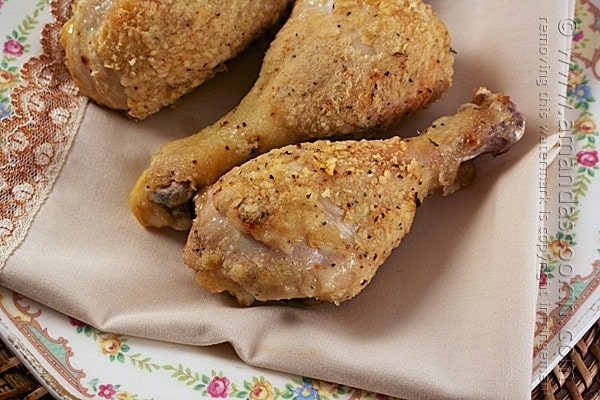 A close up photo of oven fried chicken drumsticks.