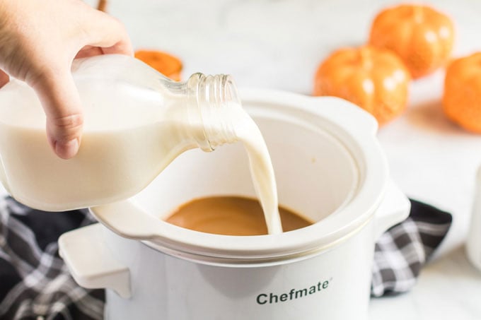 pouring milk into slow cooker