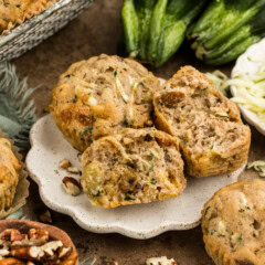 zucchini muffin sliced in half on a plate