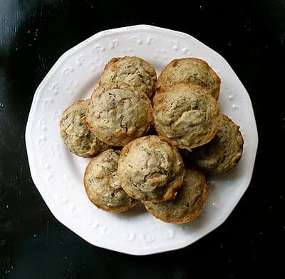 An overhead photo of vanilla zucchini muffins on a white plate.