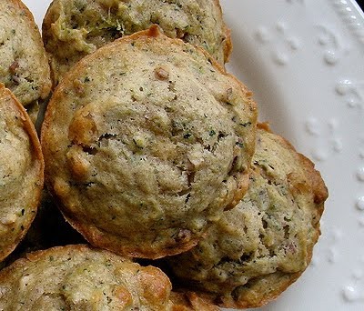 A close up overhead photo of a vanilla zucchini muffin with others in the background.