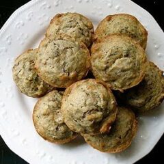 An overhead photo of vanilla zucchini muffins on a white plate.