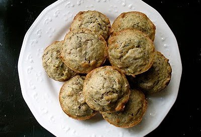 An overhead photo of vanilla zucchini muffins on a white plate.
