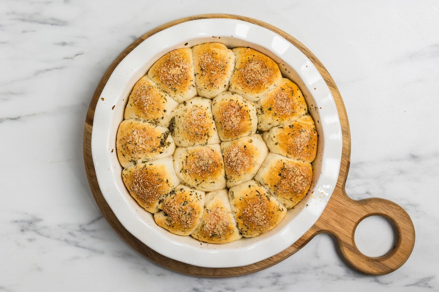meatball stuffed biscuits out of the oven on wood board