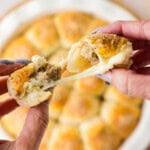 pulling a meatball stuffed biscuits apart