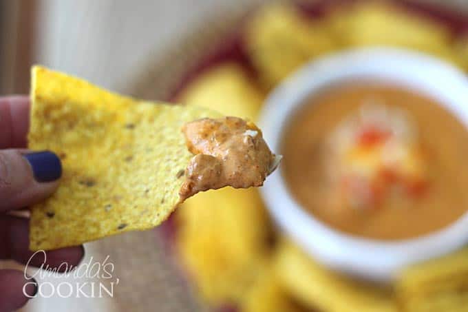 A close up of a chili dip on chip