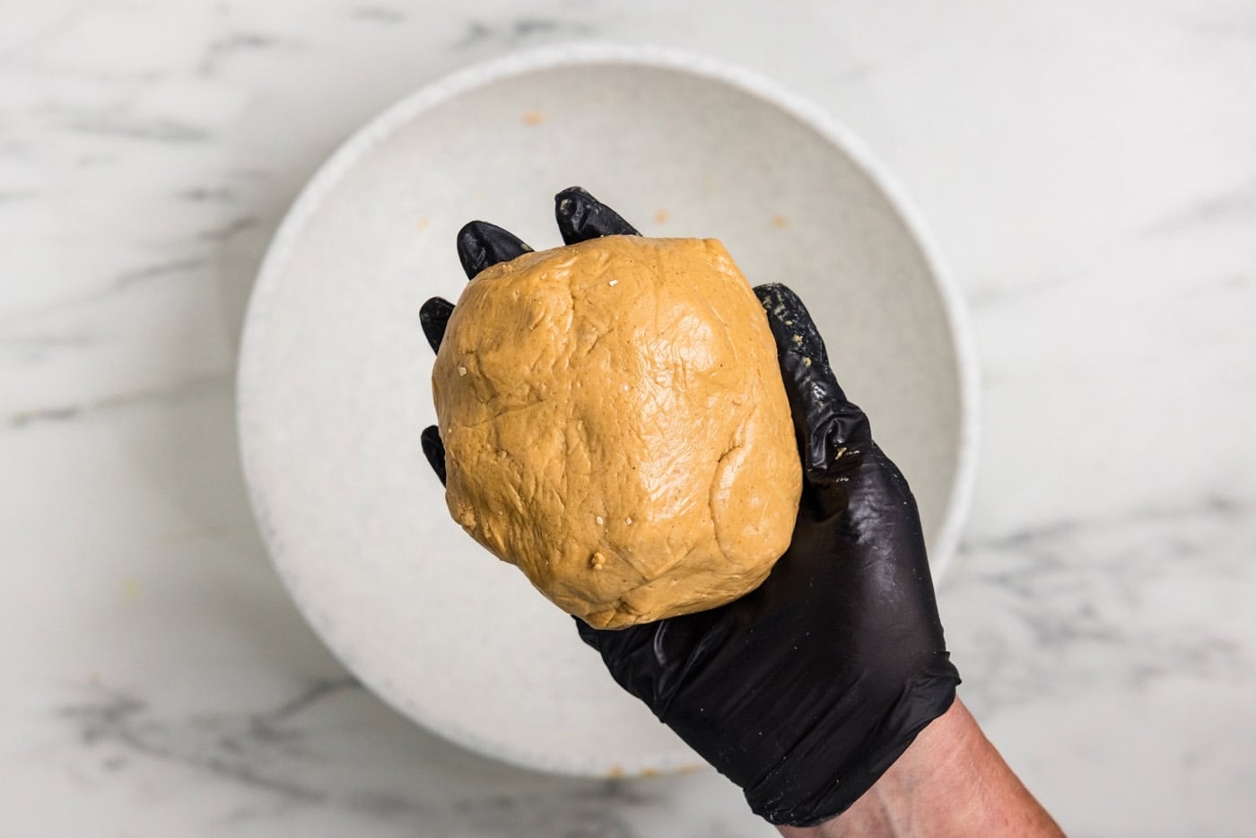 hand holding ball of dough