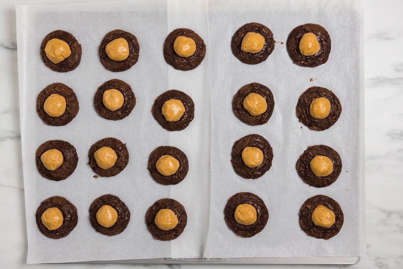 peanut butter balls on top of baked brownie balls