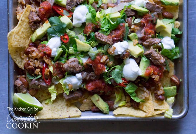 A close up overhead photo of filet mignon steak nachos.