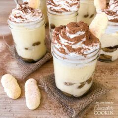 A photo of tiramisu trifles in mason jars.