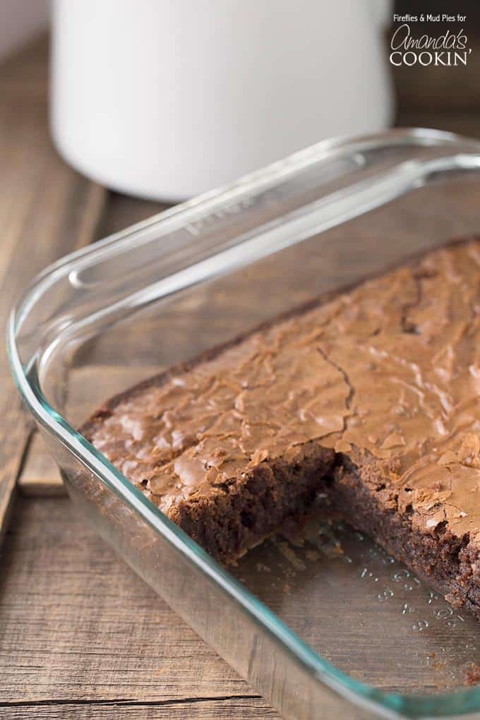 A picture of a pan of peppermint patty brownies with a square removed.