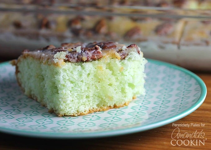 Slice of Pistachio Poke Cake on a blue plate
