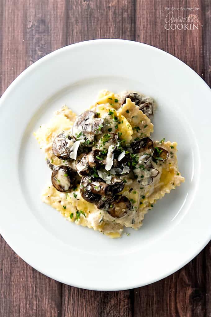 Ravioli on plate topped with mushrooms