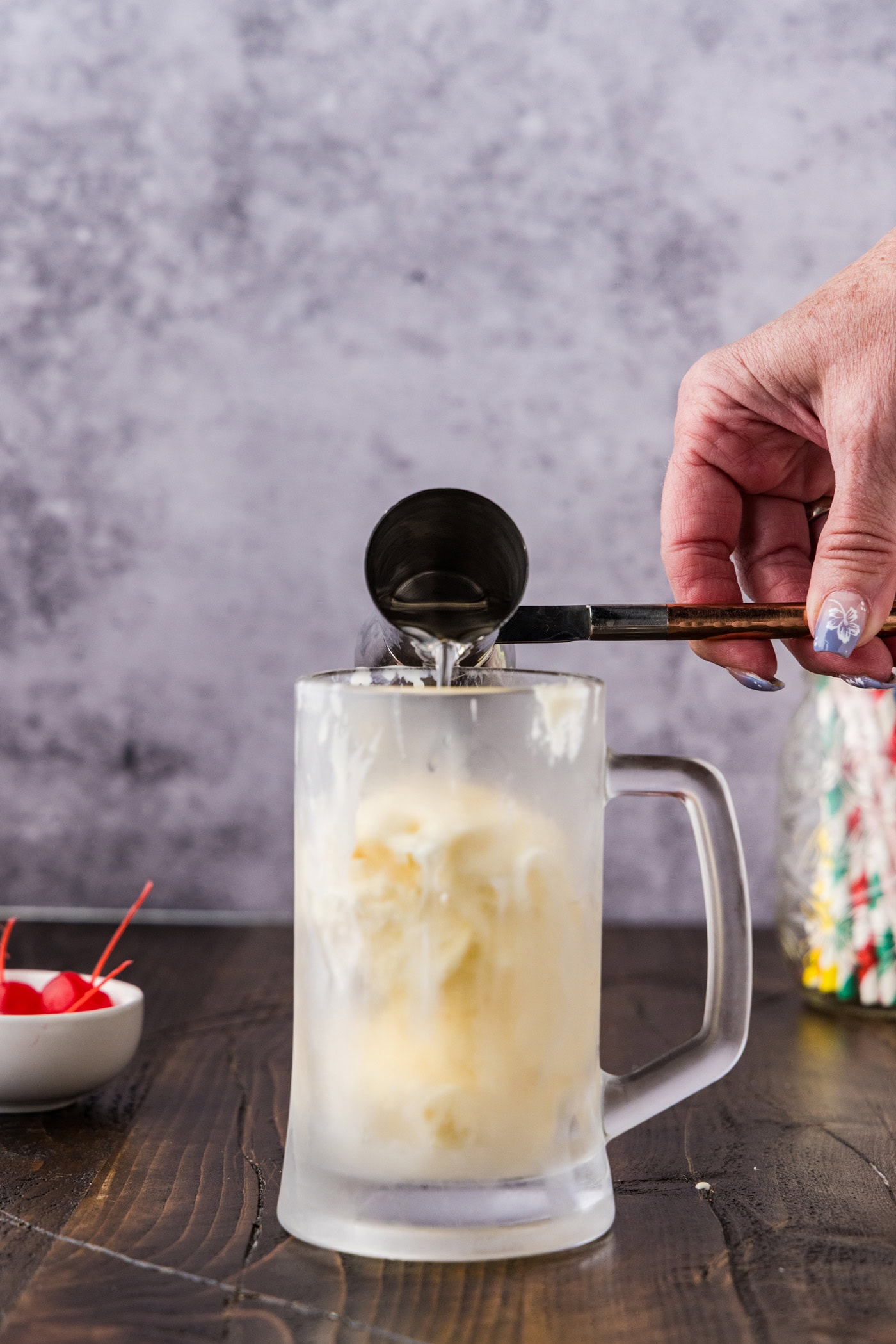 adding butterscotch schnapps to mug