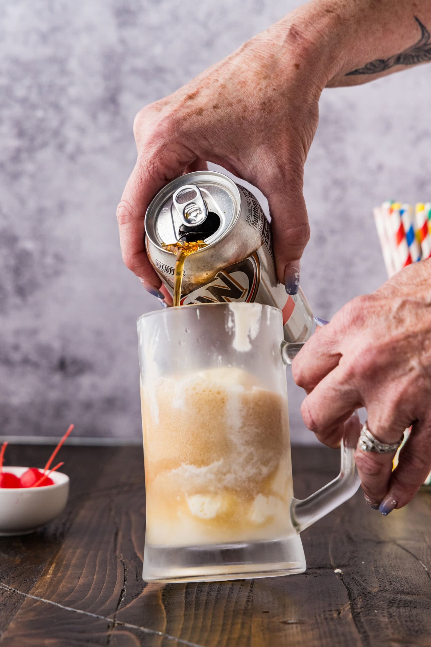 adding root beer to mug
