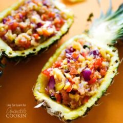 A photo of pineapple salsa served in halved pineapples.