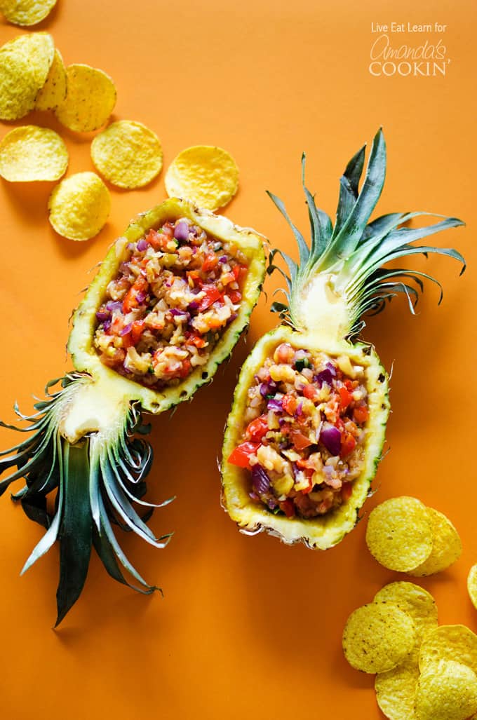 An overhead photo of pineapple salsa served in halved pineapples.