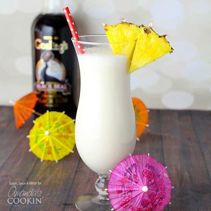 A close up photo of a Kahlua Frappuccino served with a straw and a pineapple wedge slice.