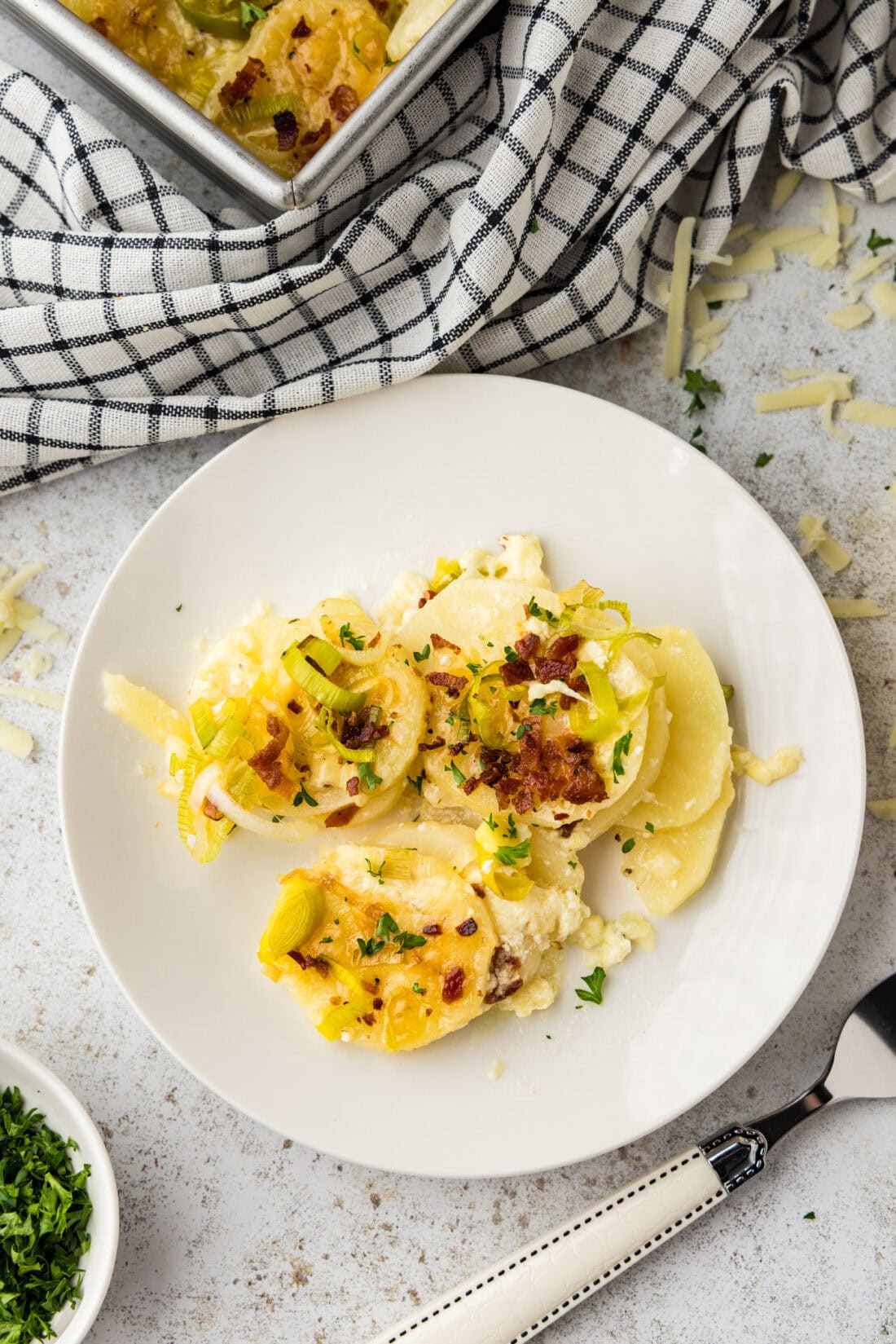 Plate of potatoes au gratin with bacon and leeks.