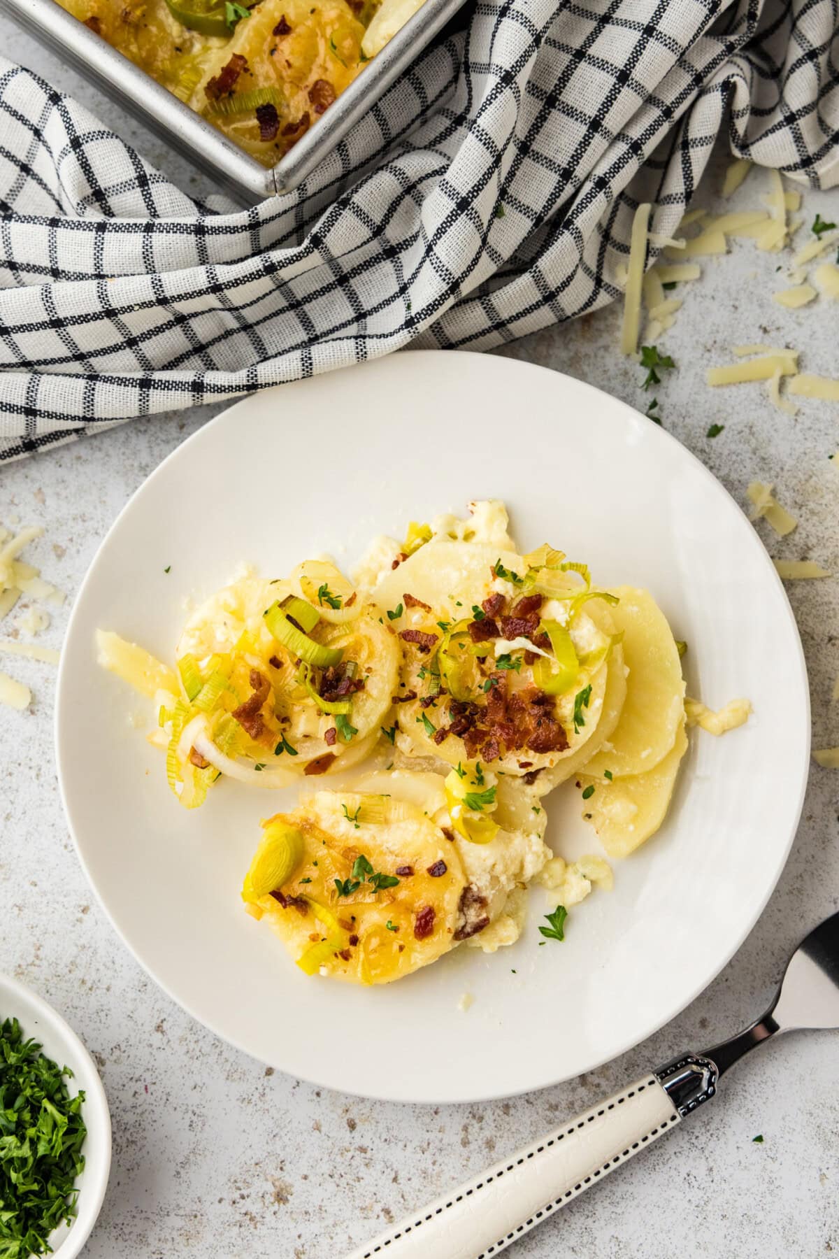 Plate of potatoes au gratin with bacon and leeks.