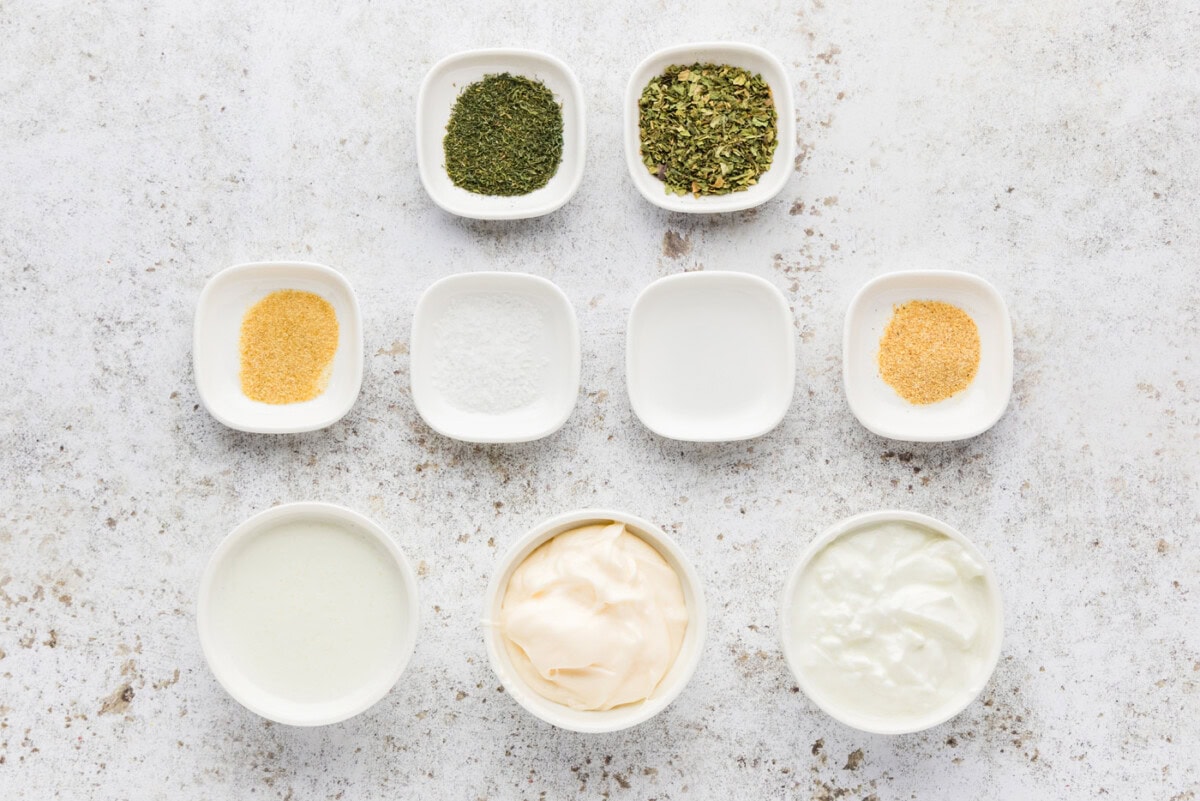 Ingredients for homemade buttermilk ranch dressing: mayonnaise, Greek yogurt, buttermilk, herbs, and spices