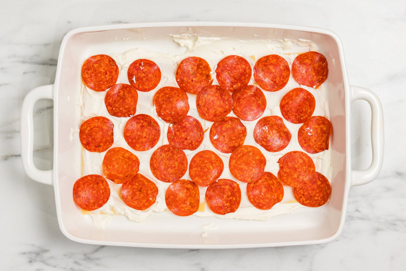 pepperoni slices layered over ricotta cheese