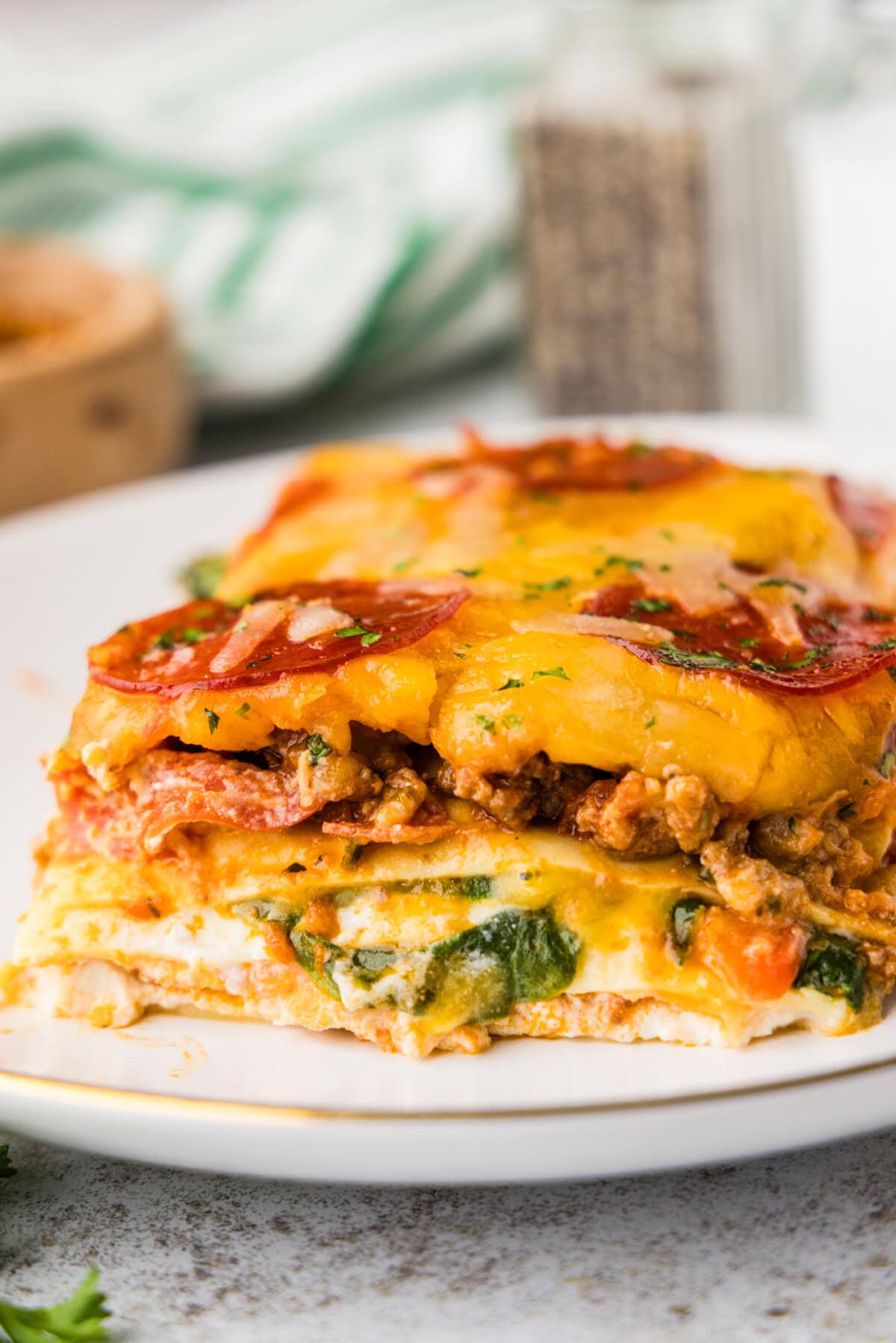 slice of pizza lasagna on white plate