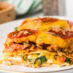 slice of pizza lasagna on white plate