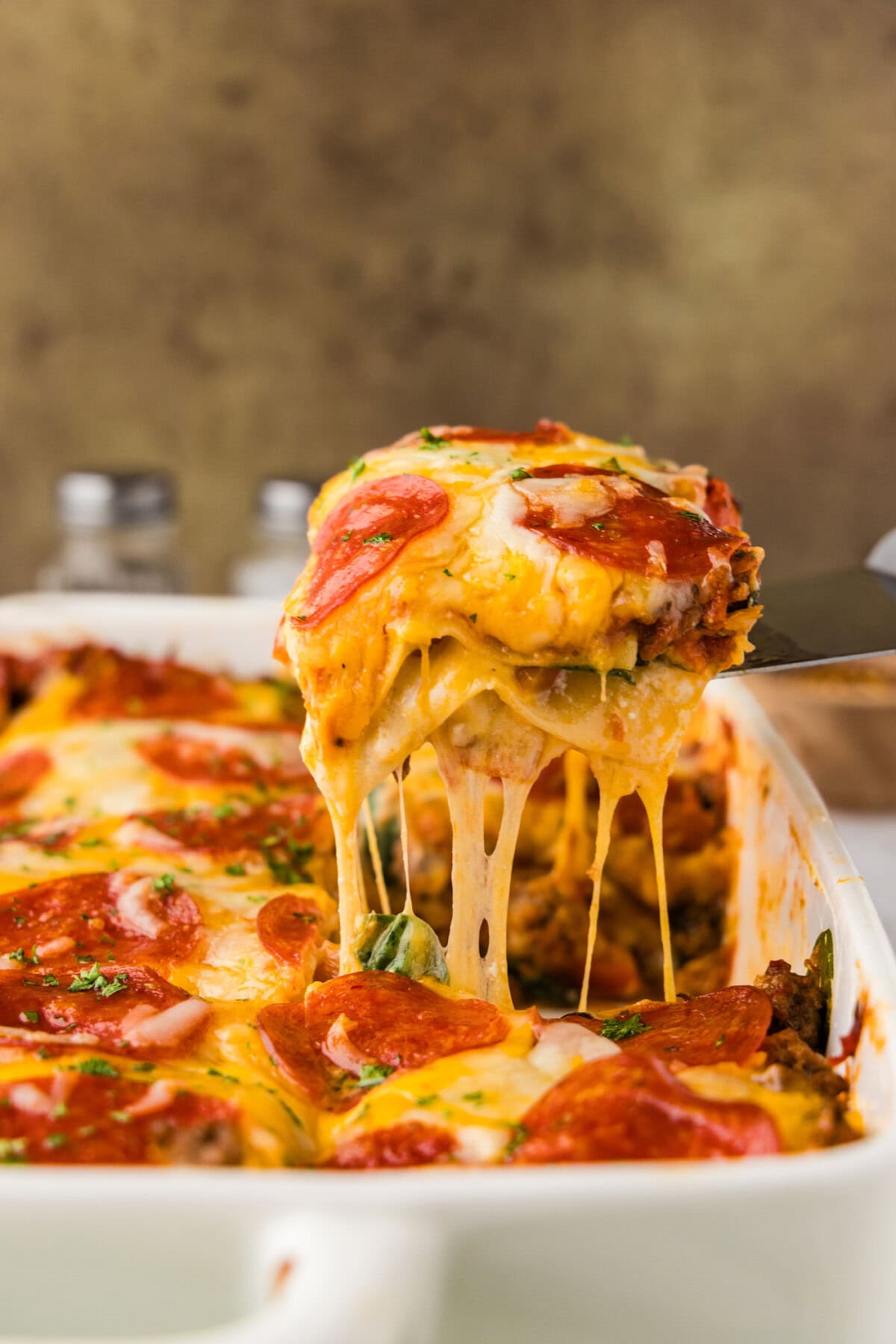 spatula lift shot of pizza lasagna