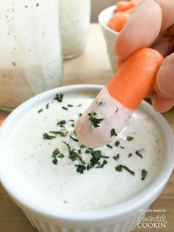 dipping carrot into dressing