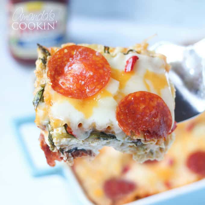 A close up of pizza lasagna on a spatula.
