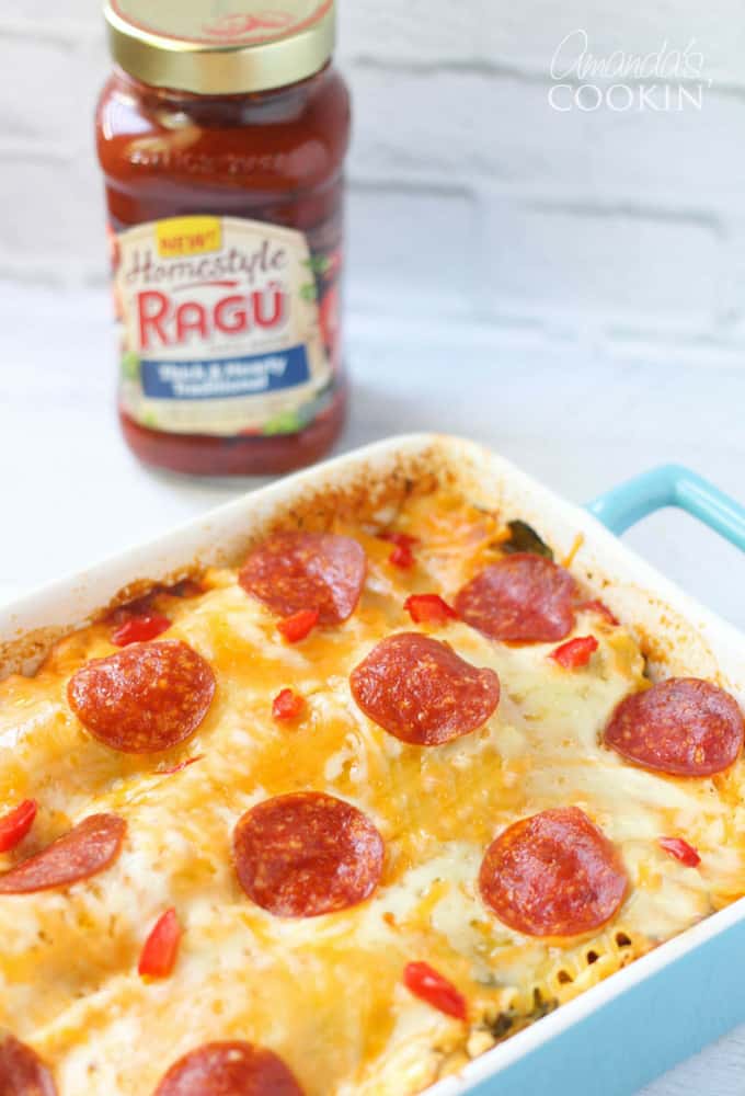 A close up photo of pizza lasagna in a blue casserole dish.