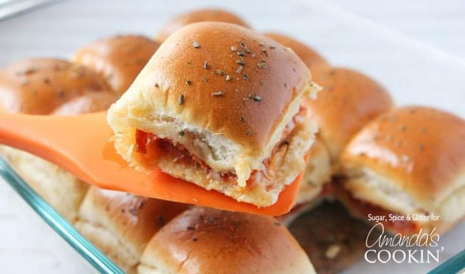 A close up of pizza slider on a spatula.