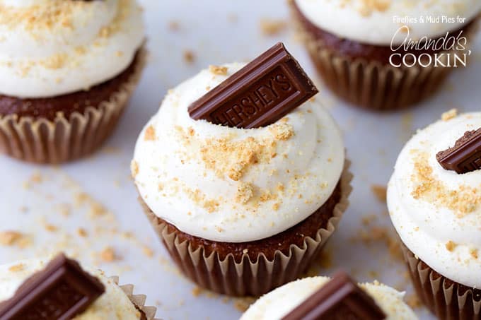 A close up of a s\'mores cupcake topped with a Hershey bar piece. 