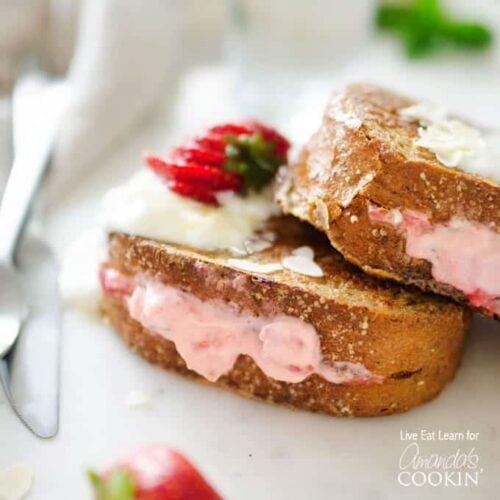 A close up of a strawberry cream french toast on a plate