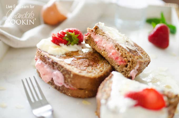 A piece of french toast with strawberries and cream