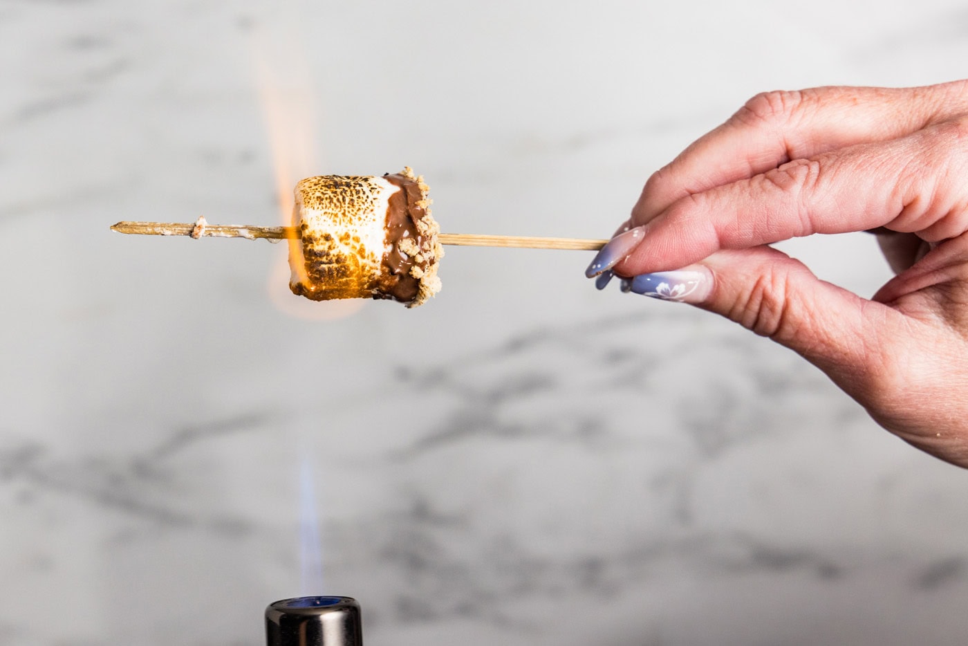 roasting a marshmallow with a kitchen torch