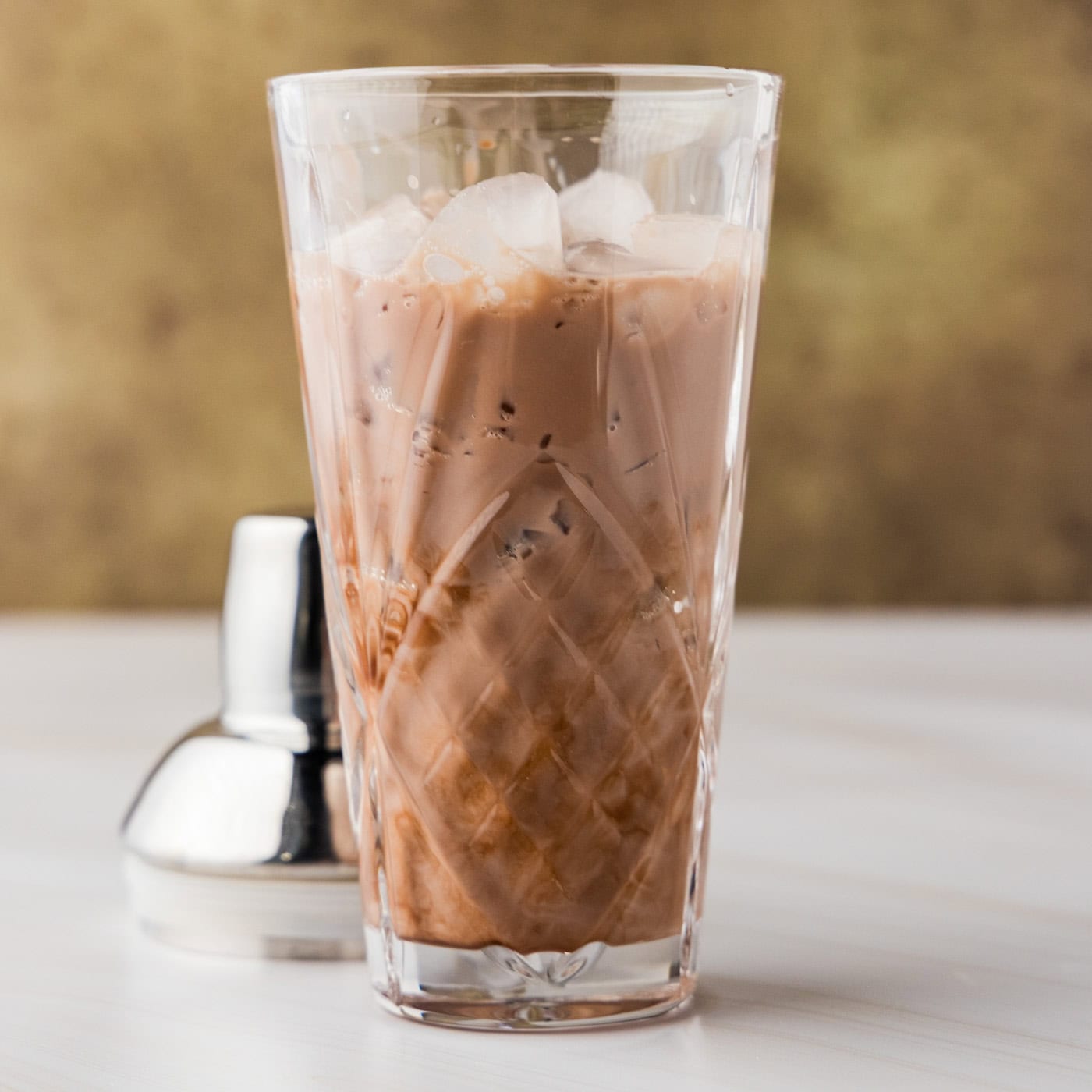 whipped cream vodka, chocolate liqueur and half and half in a cocktail shaker for a S'mores Martini
