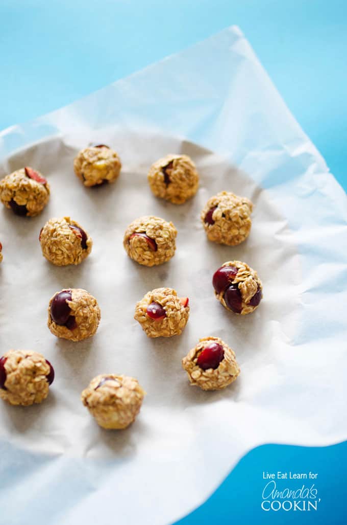 An overhead photo of cherry cheesecake energy balls on a plate.