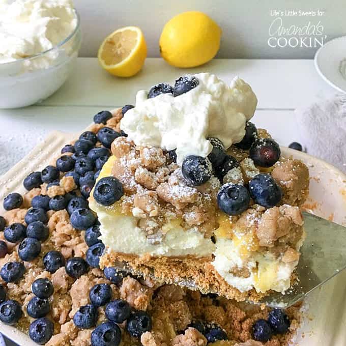 A square of blueberry lemon crumble no bake cheesecake on a spatula.