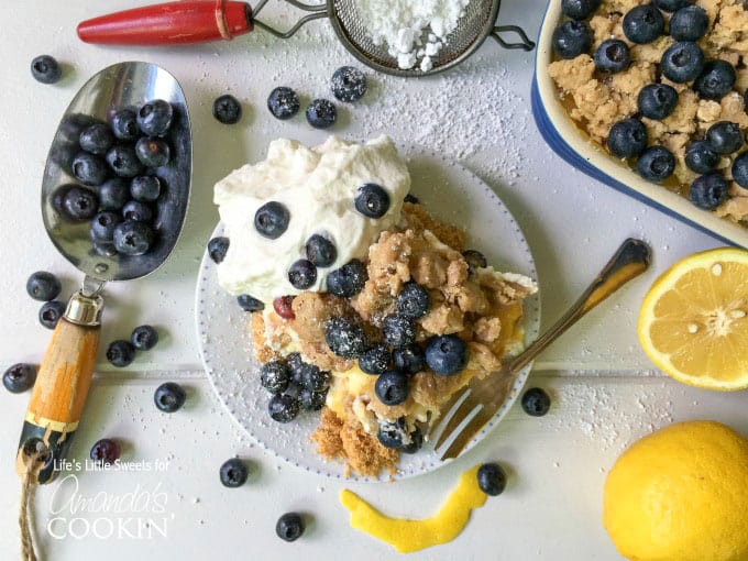 An overhead of blueberry lemon crumble no bake cheesecake on a plate topped with fresh blueberries.