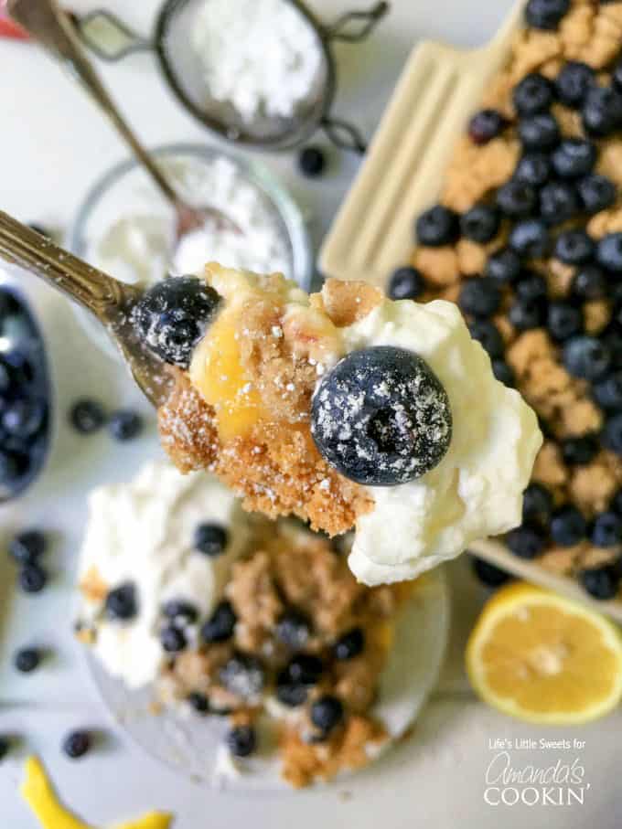 A close up of a spoonful of blueberry lemon crumble no bake cheesecake.
