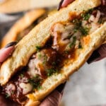 hands holding a Slow Cooker BBQ Meatball Sub