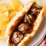 Slow Cooker BBQ Meatball Sub on a plate with chips